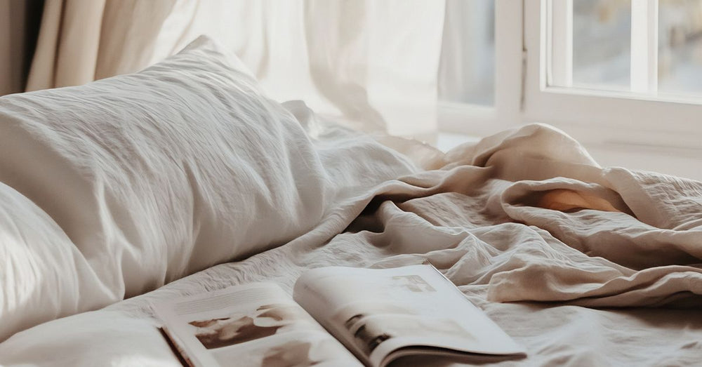 Peaceful unmade bed with soft morning light and open book – representing natural sleep support for women